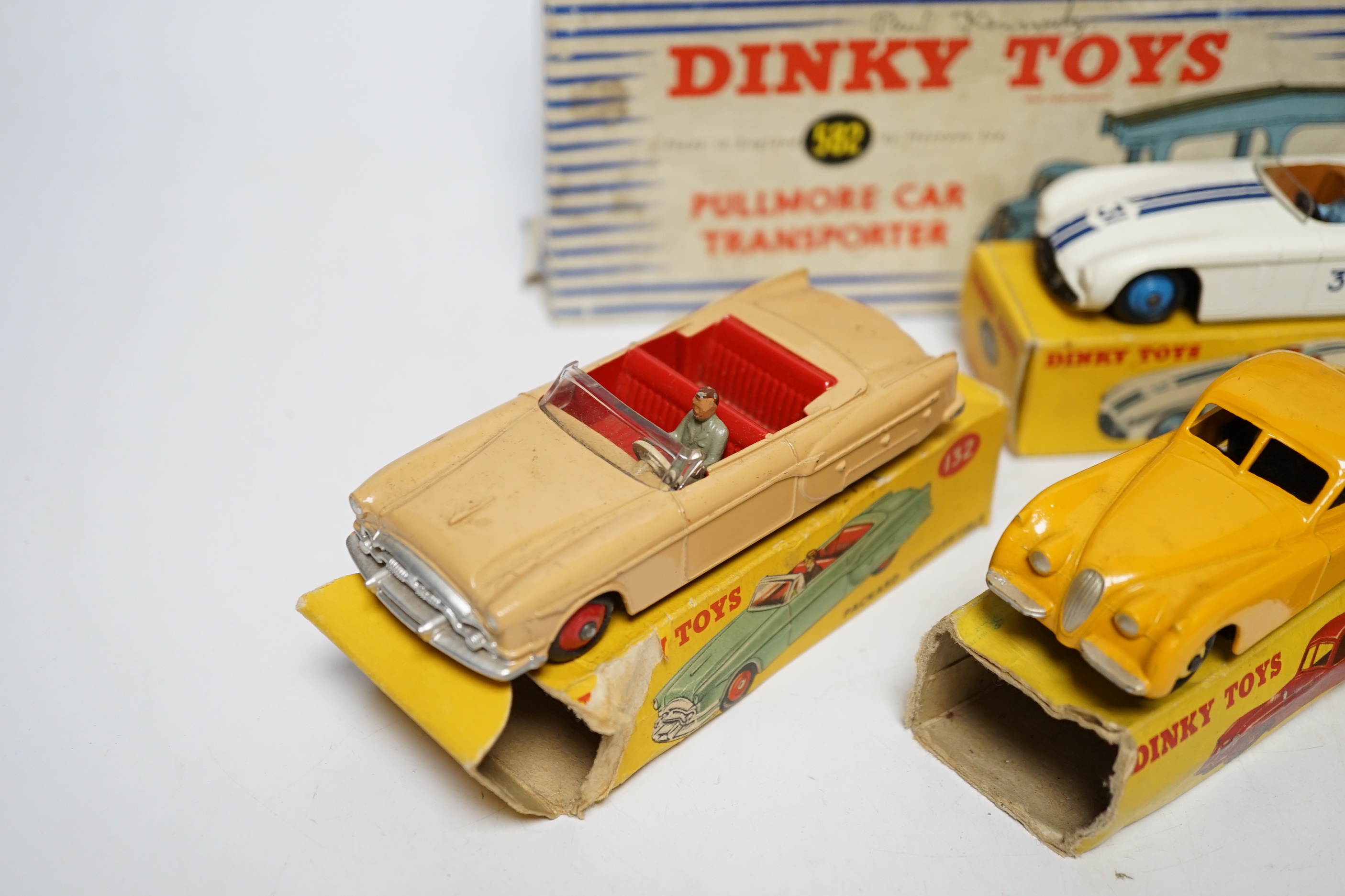 Five boxed Dinky Toys; (132) a Packard Convertible, (131) a Cadillac Tourer, (133) a Cunningham C-5R road racer, (157) a Jaguar XK120 and (582) a Pullmore Car Transporter with a (994) Loading Ramp, together with a Cresce